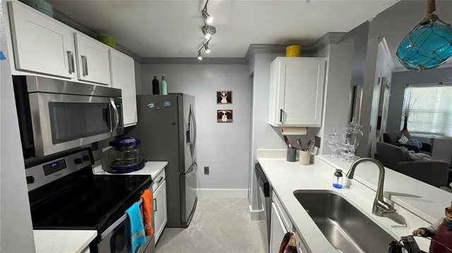 a view of a dining room with furniture and a chandelier