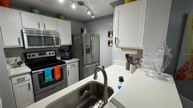 a bathroom with a light fixture a sink and mirror