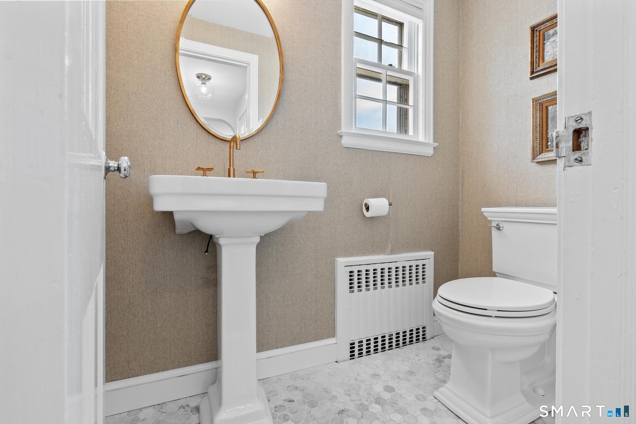 40 Fairlee Road West Hartford, CT 06107 - Photo 19 of 40 Main level powder room with classic pedestal sink and updated finishes.