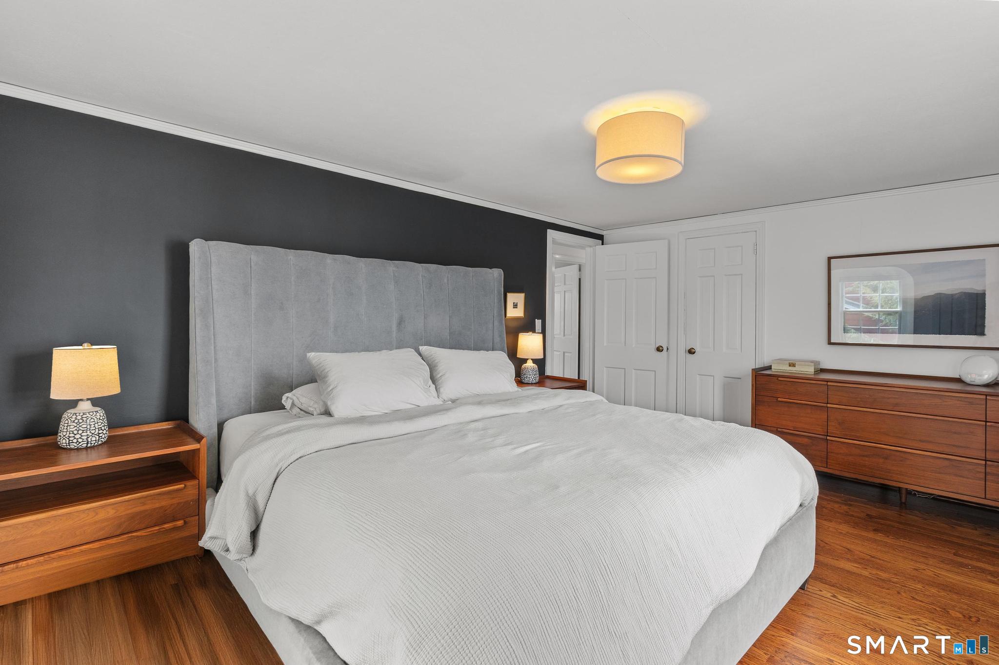 40 Fairlee Road West Hartford, CT 06107 - Photo 26 of 40 Comfortable primary bedroom with hardwood floors and stylish accent wall.
