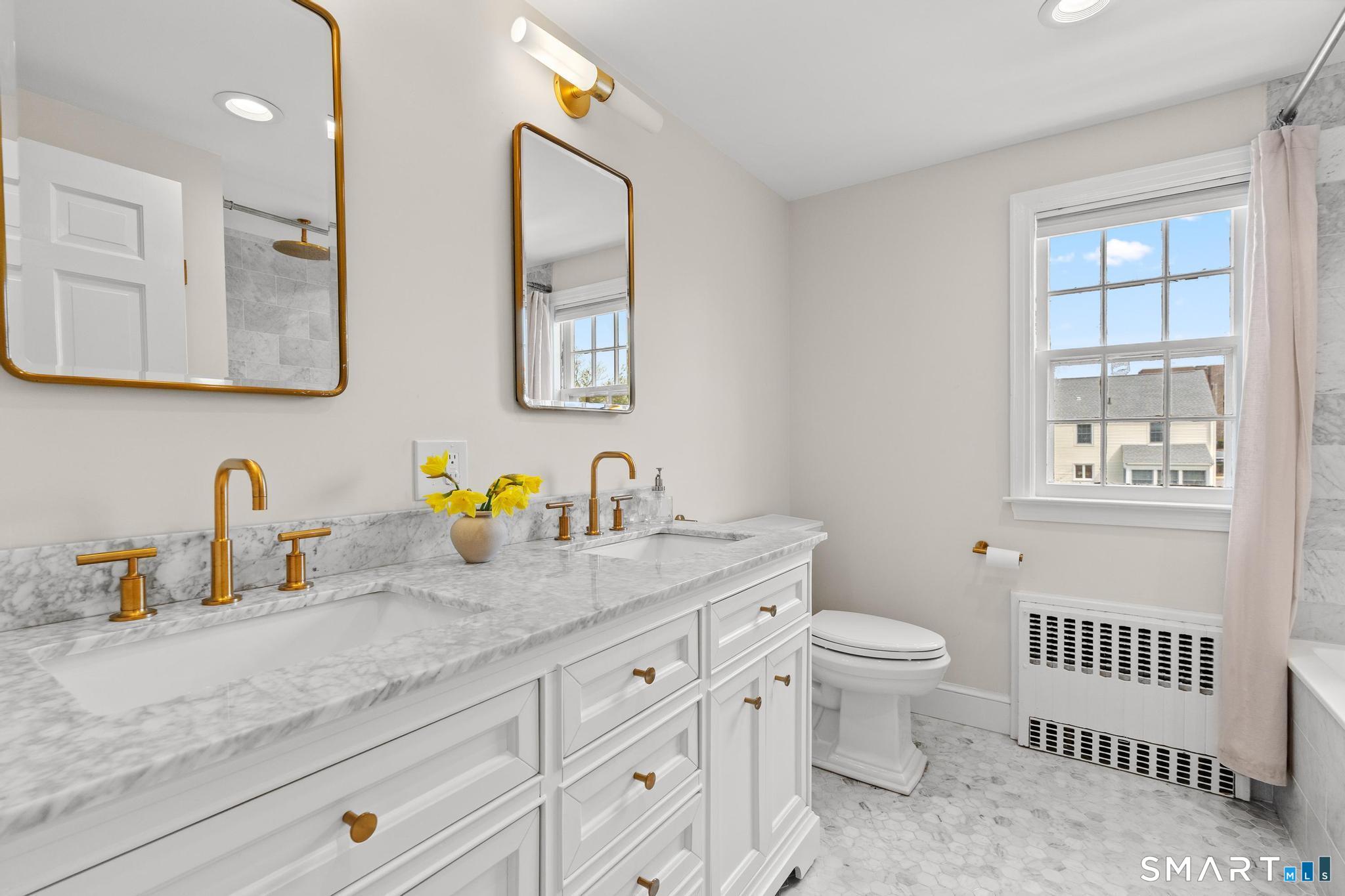 40 Fairlee Road West Hartford, CT 06107 - Photo 30 of 40 Renovated full bath with Carrara marble countertops, double sinks, and soaking tub.