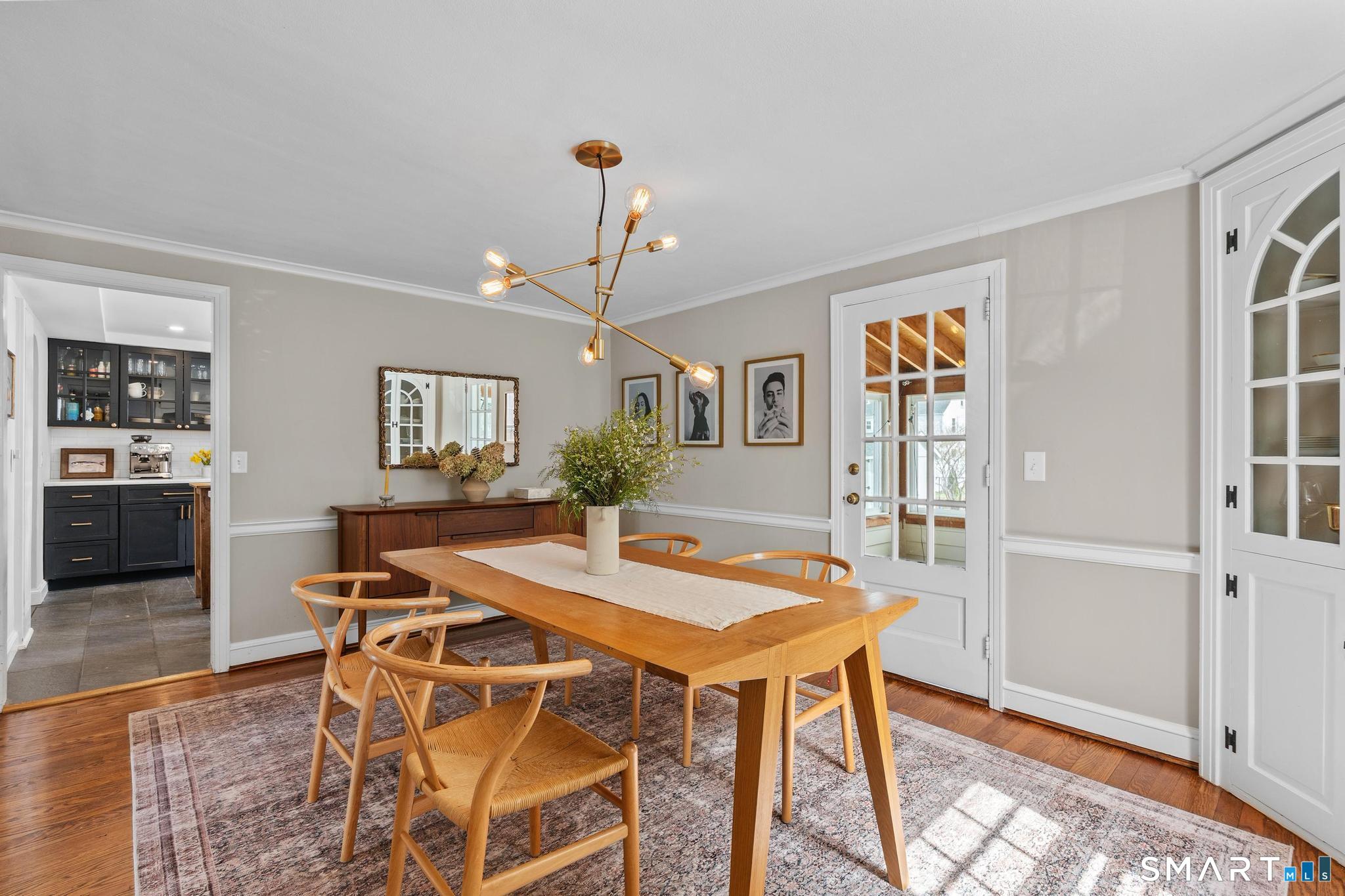 40 Fairlee Road West Hartford, CT 06107 - Photo 7 of 40 Formal dining room with hardwood floors, built-in corner hutch, and modern lighting.
