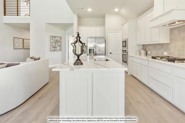 a kitchen with a sink a stove and cabinets