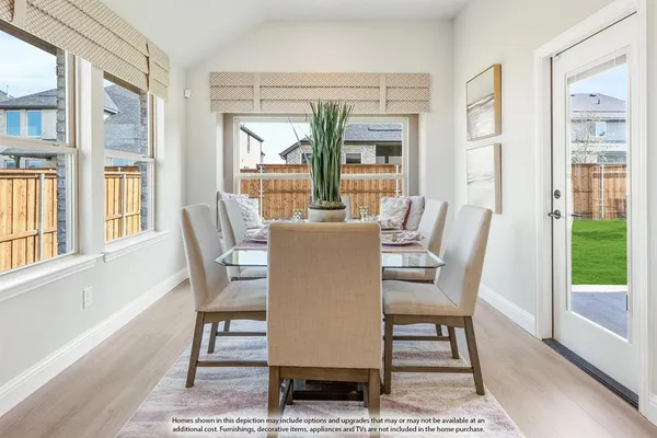 a dining room with furniture a rug and wooden floor