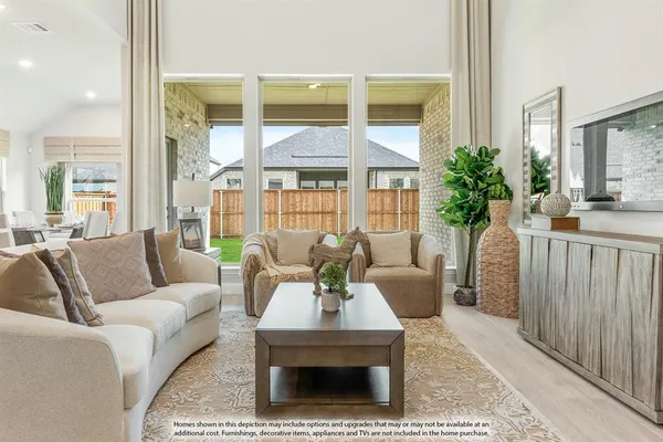 a living room with furniture a large window and a table