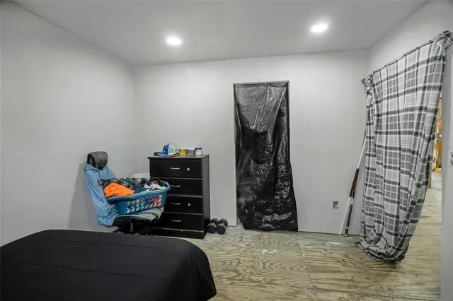 a view of livingroom with furniture and a refrigerator