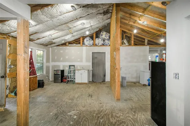 a view of a hallway with furniture