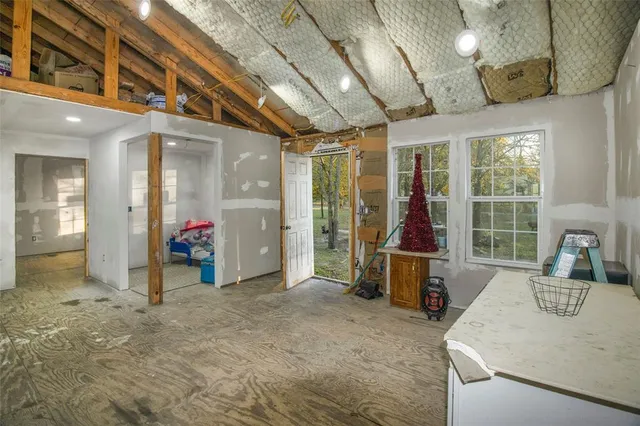 a bedroom with furniture and a flat screen tv