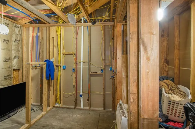 a kitchen with granite countertop a refrigerator stove and wooden floor
