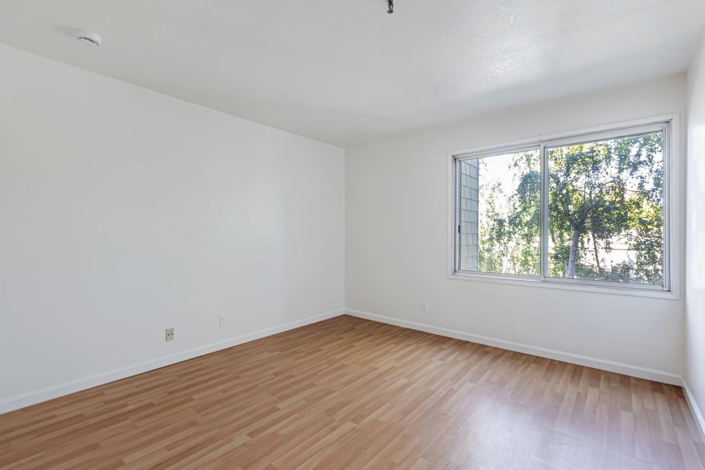 49 Showers Drive, Unit W203 Mountain View, CA 94040 - Photo 12 of 38 wooden floor in an empty room with a window
