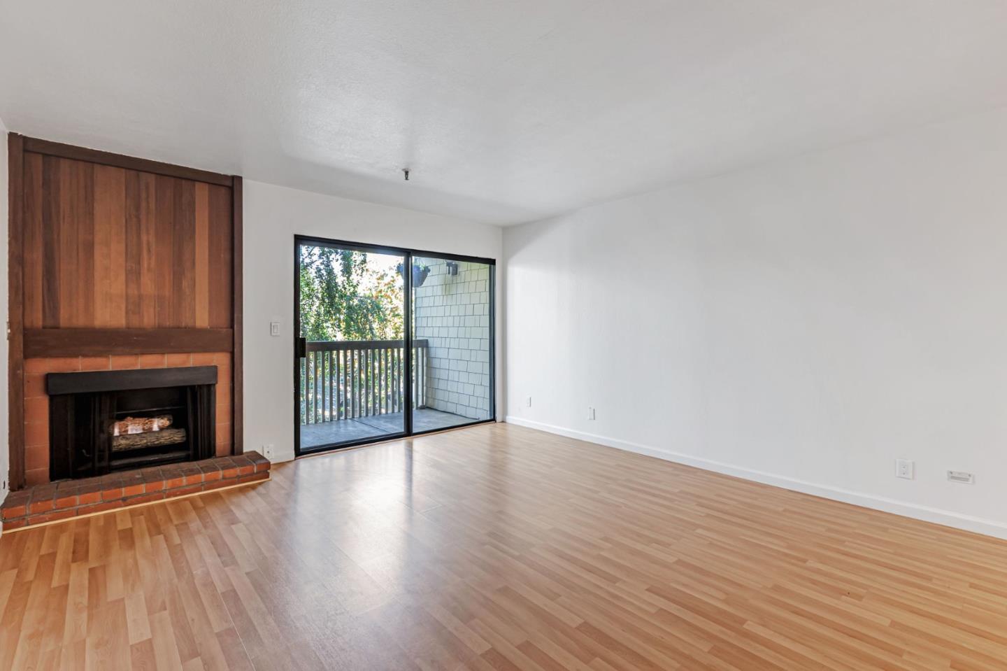 49 Showers Drive, Unit W203 Mountain View, CA 94040 - Photo 17 of 38 an empty room with wooden floor fireplace and windows