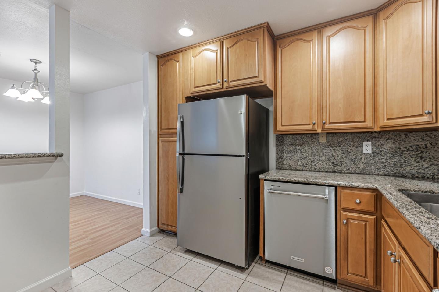 49 Showers Drive, Unit W203 Mountain View, CA 94040 - Photo 22 of 38 a kitchen with granite countertop cabinets and refrigerator