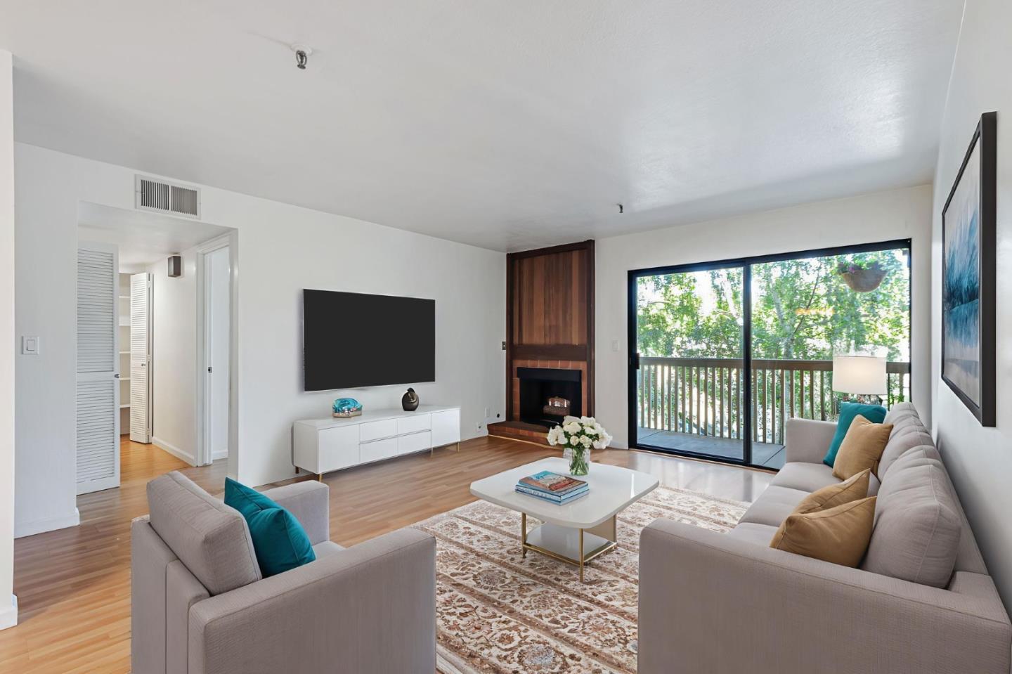 49 Showers Drive, Unit W203 Mountain View, CA 94040 - Photo 3 of 38 a living room with furniture and a flat screen tv
