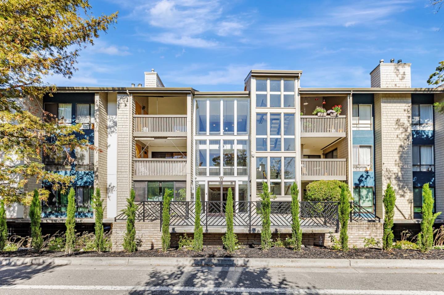 49 Showers Drive, Unit W203 Mountain View, CA 94040 - Photo 37 of 38 a front view of a building with a garden and plants