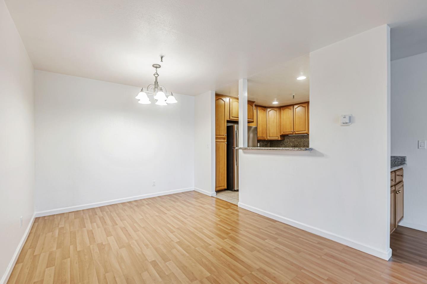 49 Showers Drive, Unit W203 Mountain View, CA 94040 - Photo 5 of 38 a view of a kitchen with a sink and dishwasher with wooden floor