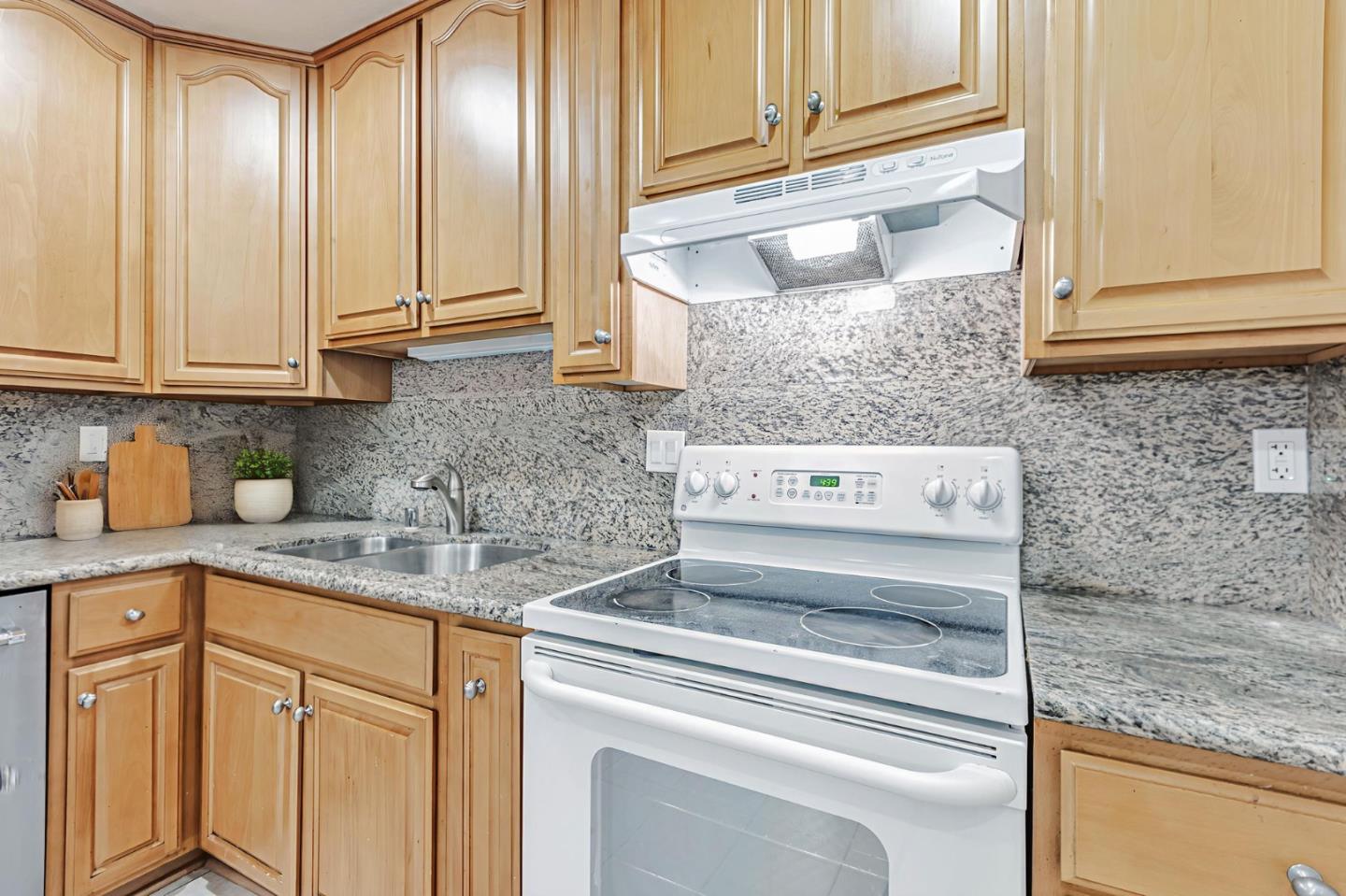 49 Showers Drive, Unit W203 Mountain View, CA 94040 - Photo 6 of 38 a kitchen with granite countertop cabinets and window