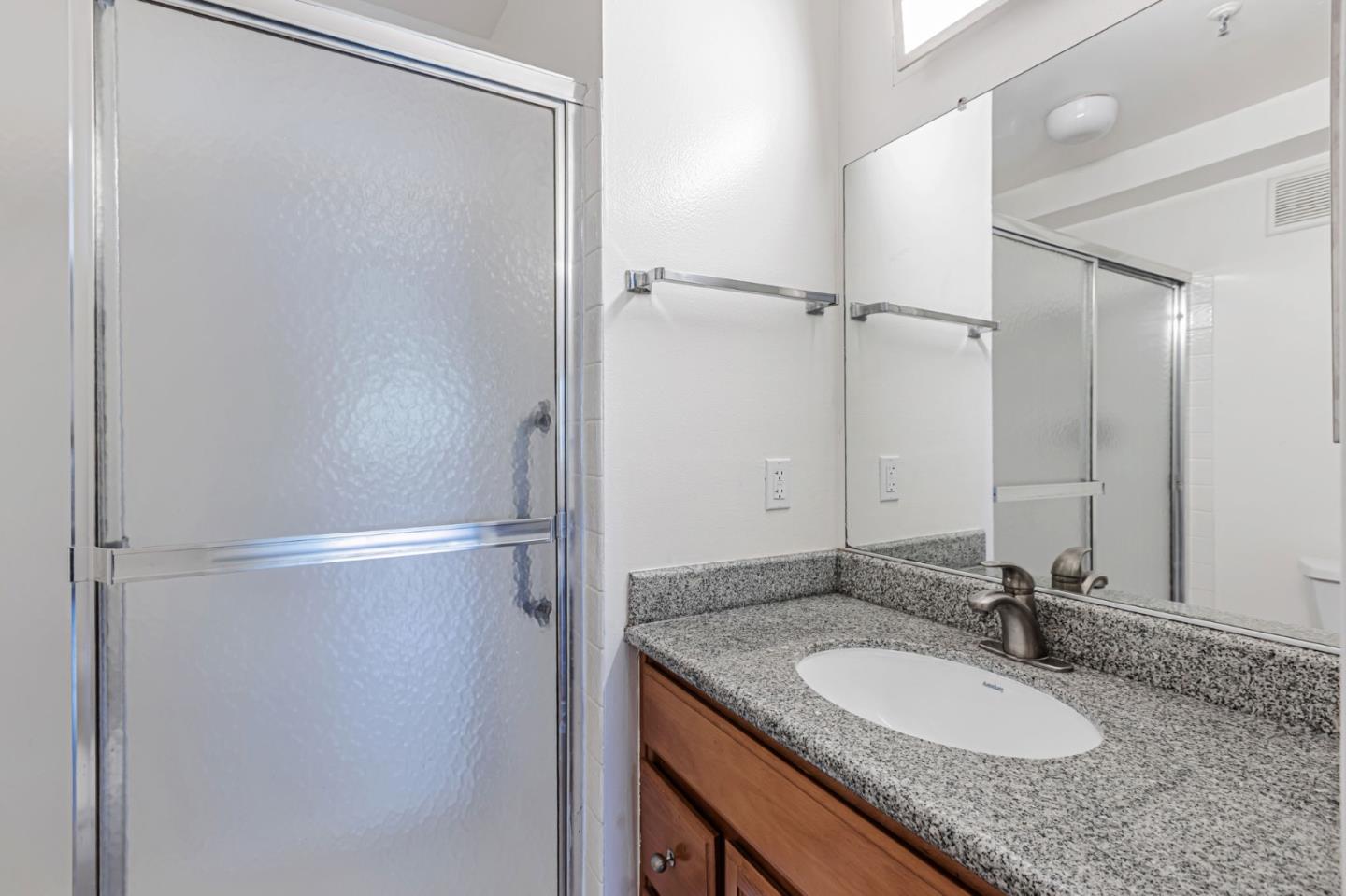 49 Showers Drive, Unit W203 Mountain View, CA 94040 - Photo 10 of 38 a bathroom with a granite countertop shower sink and mirror