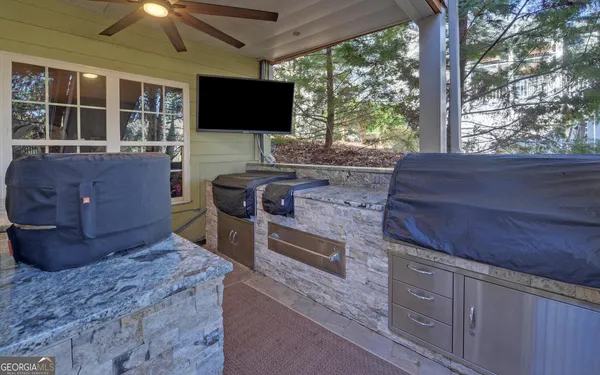a view of a house with a chairs and table in a patio