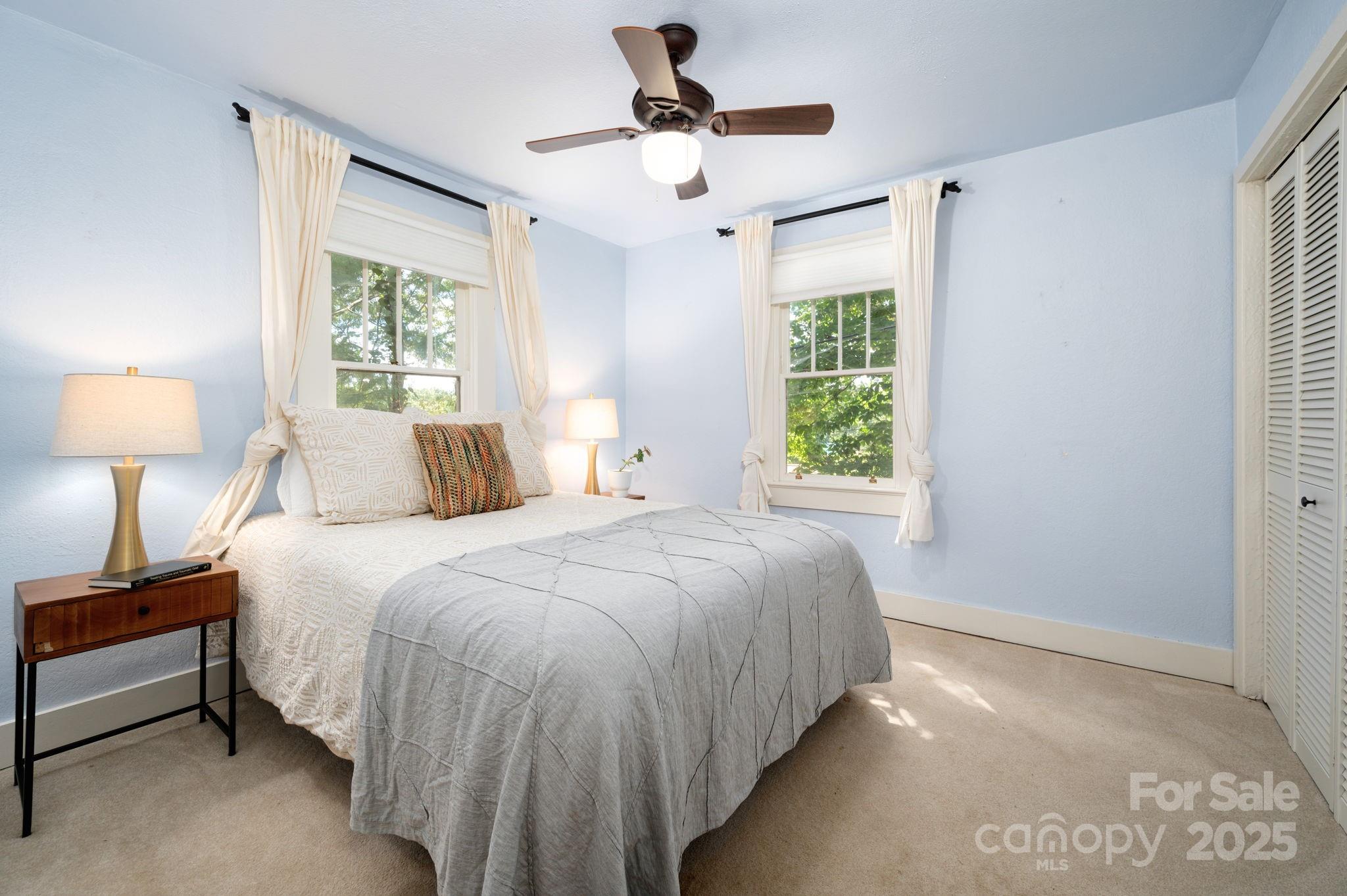 115 Oakland Road Asheville, NC 28801 - Photo 11 of 32 a bedroom with a bed and a window