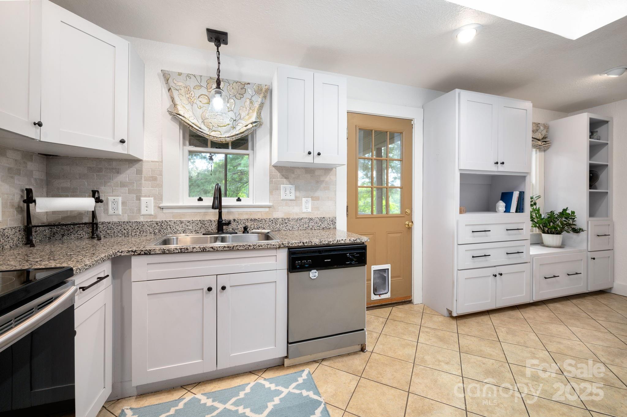 115 Oakland Road Asheville, NC 28801 - Photo 15 of 32 a kitchen with a sink and cabinets