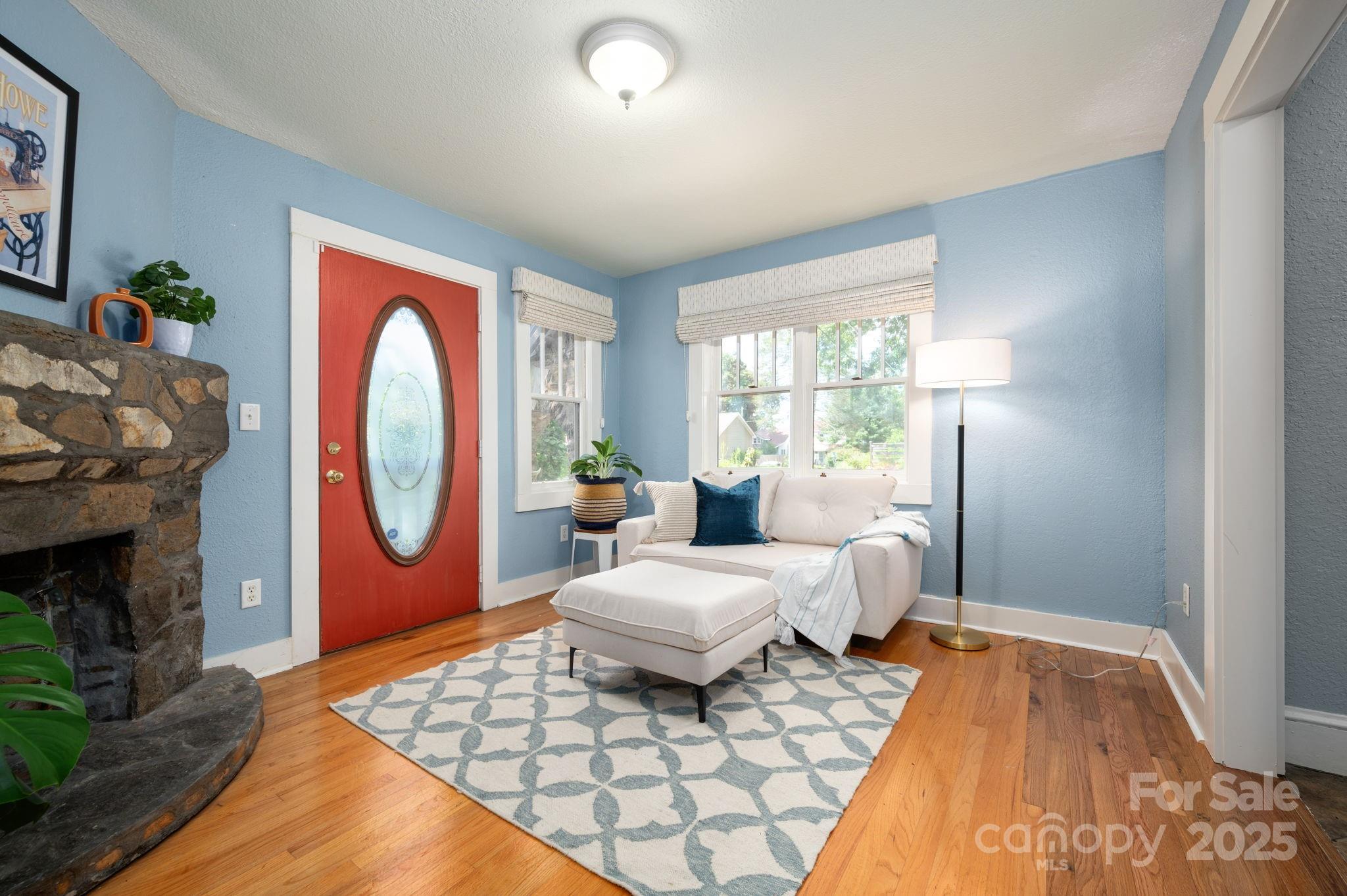 115 Oakland Road Asheville, NC 28801 - Photo 20 of 32 a living room with furniture a rug and a fireplace
