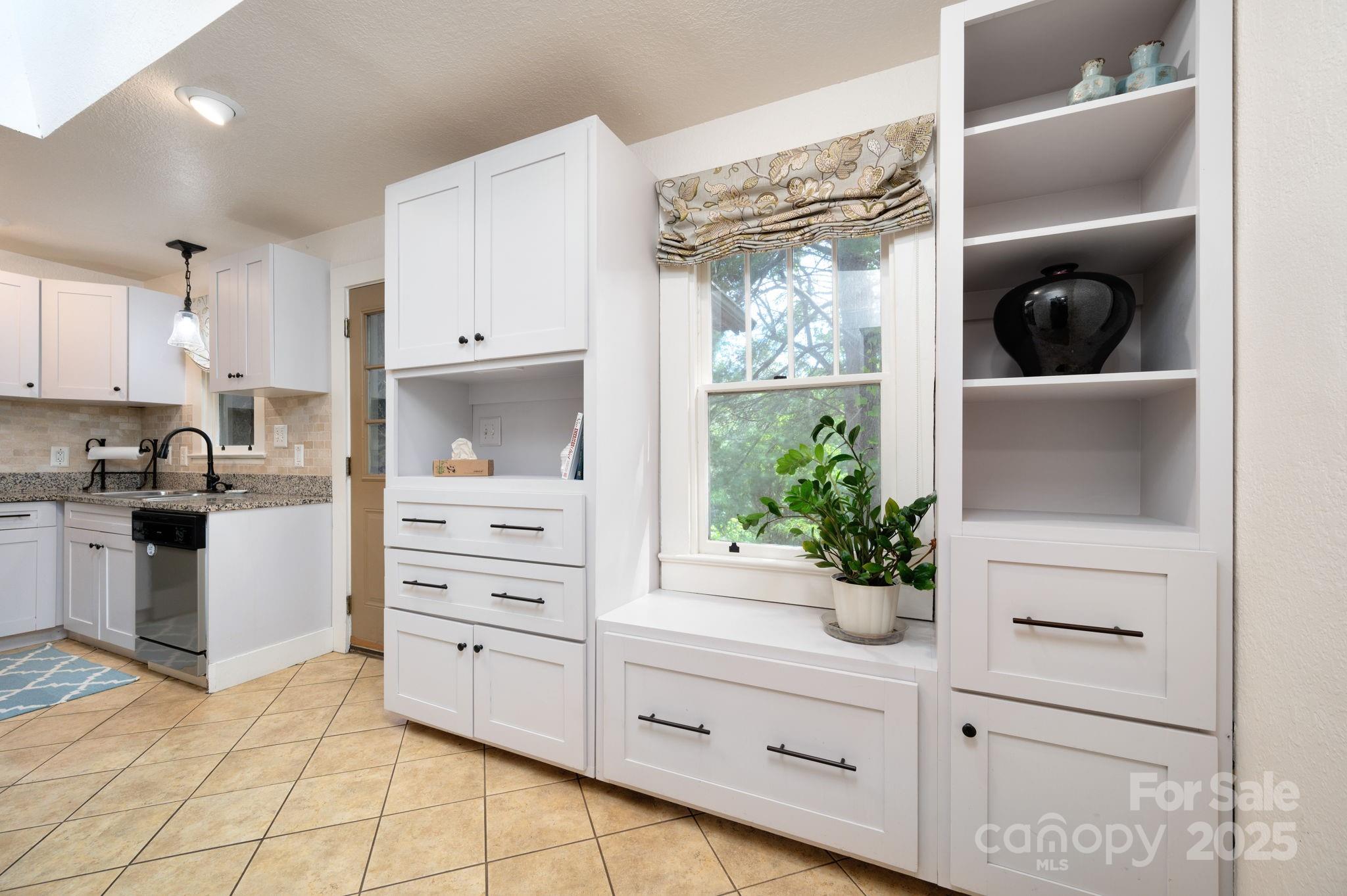 115 Oakland Road Asheville, NC 28801 - Photo 23 of 32 a kitchen with a refrigerator and white cabinets