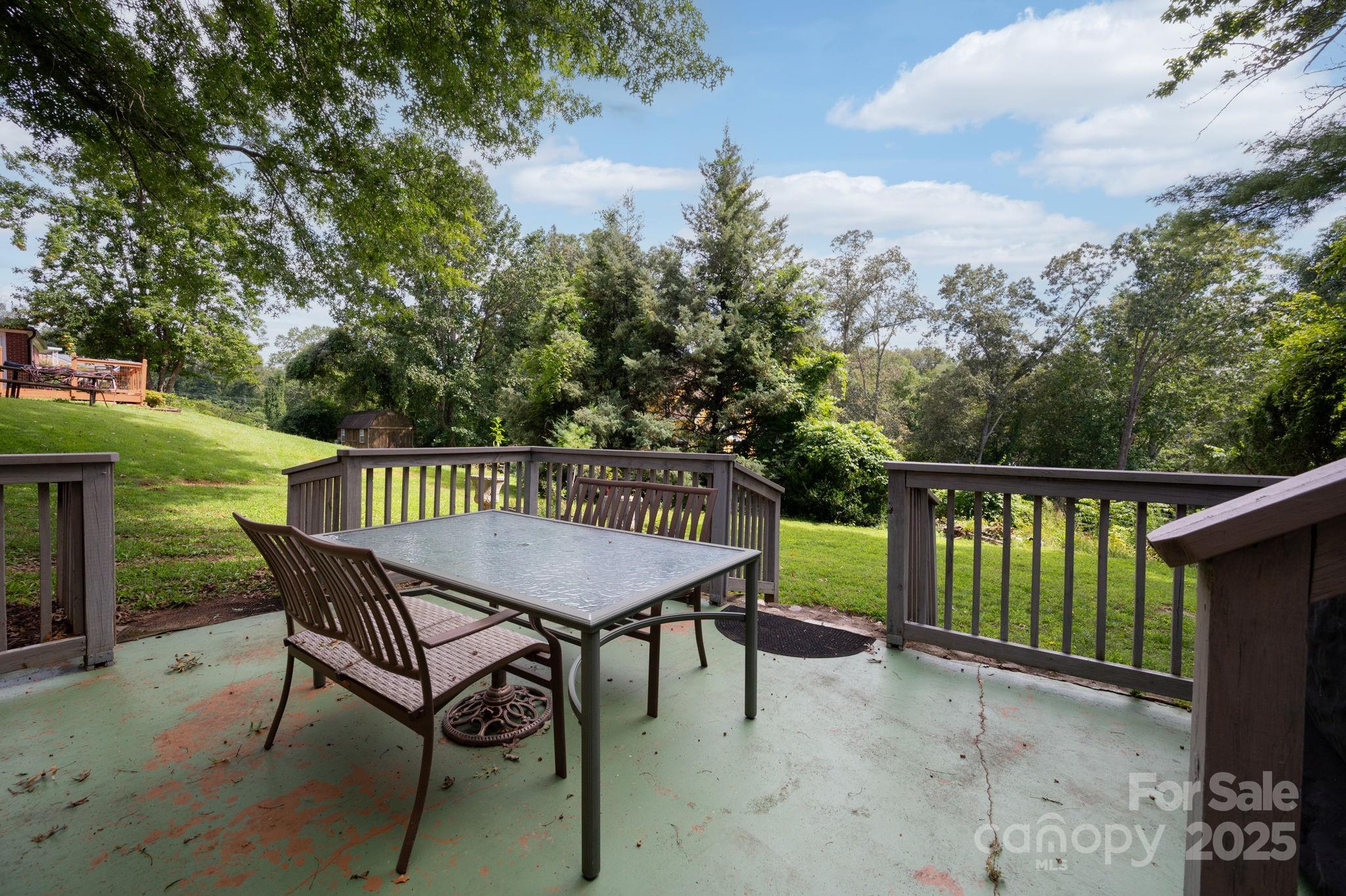 115 Oakland Road Asheville, NC 28801 - Photo 26 of 32 a balcony with wooden floor table and chairs