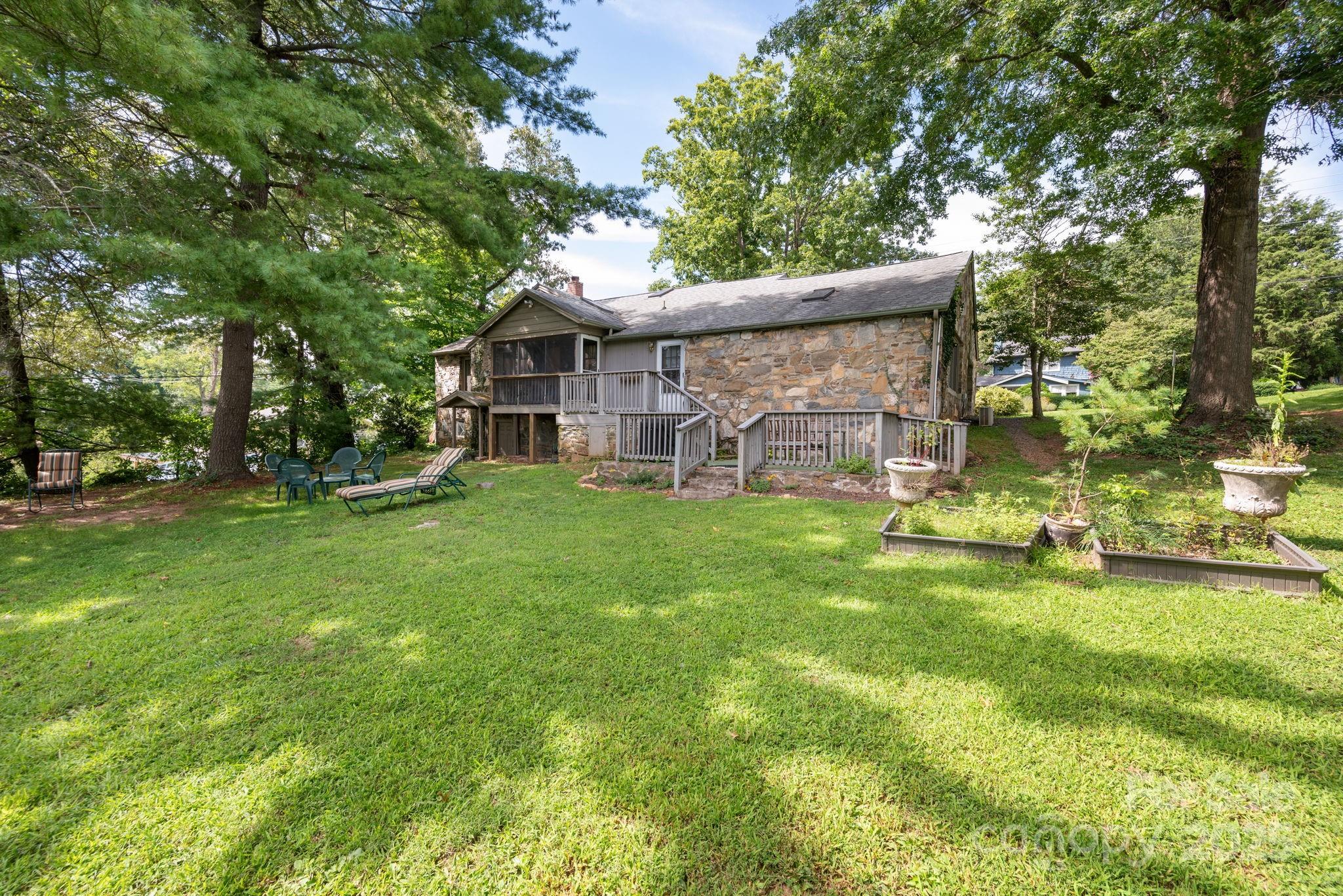115 Oakland Road Asheville, NC 28801 - Photo 28 of 32 a view of a house with a big yard and large trees