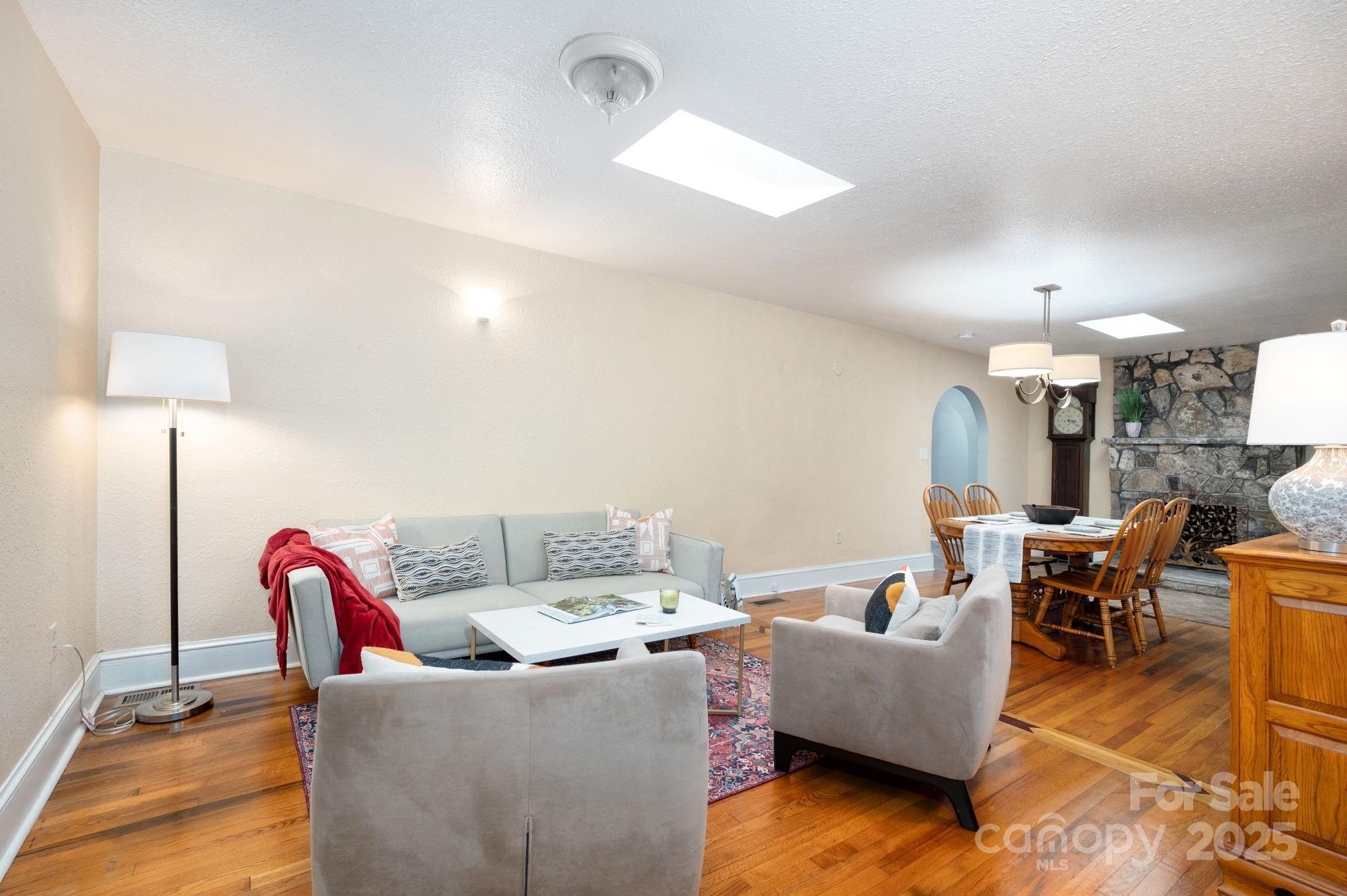 115 Oakland Road Asheville, NC 28801 - Photo 4 of 32 a living room with furniture a dining table and a lamp