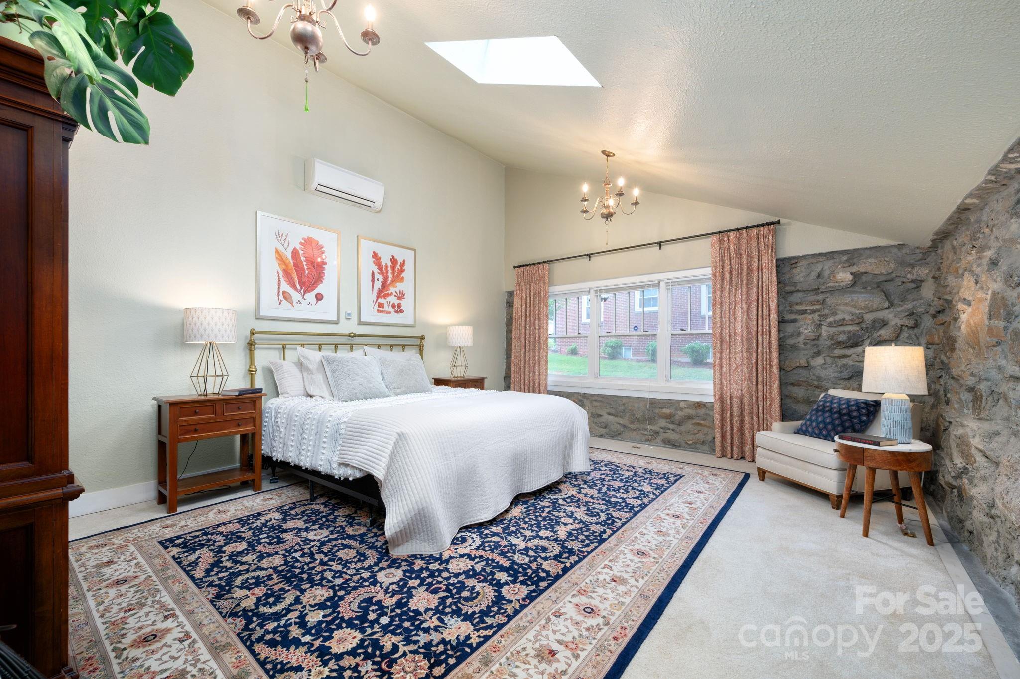 115 Oakland Road Asheville, NC 28801 - Photo 7 of 32 a bed room with a bed and a couch