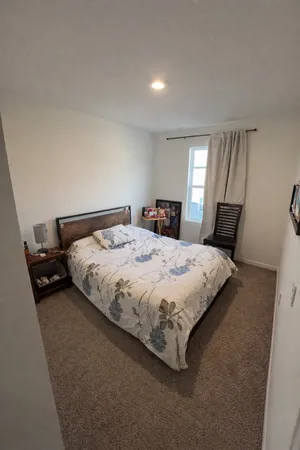 a bedroom with a bed and window
