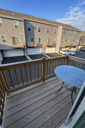 a view of a roof deck with wooden floor and seating space