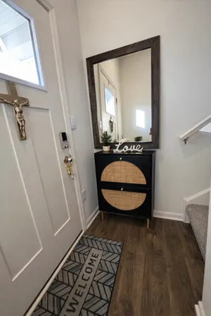 a bathroom with a sink a mirror a toilet and a window
