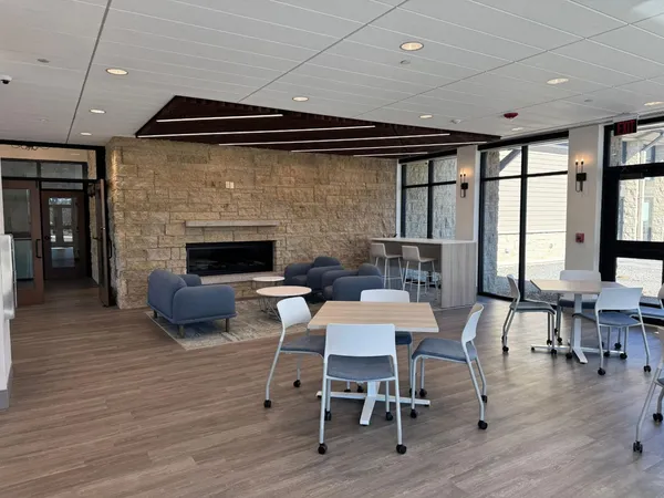 a dining room with furniture window and wooden floor