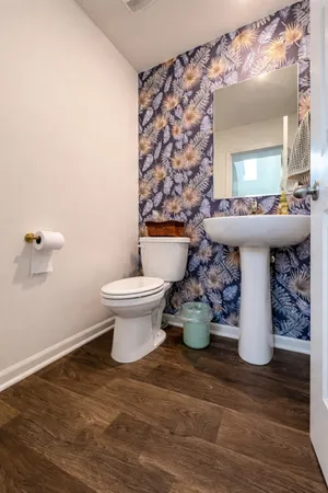 a bathroom with a sink toilet and a mirror