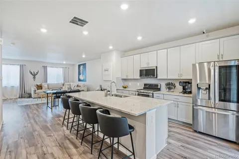 a kitchen with appliances a sink a counter top space and cabinets