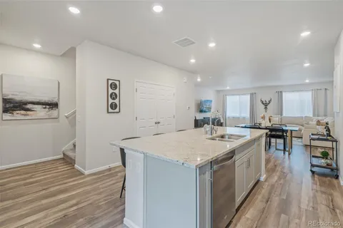 a large kitchen with a table and chairs