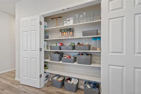a room with a wooden floor and shelf
