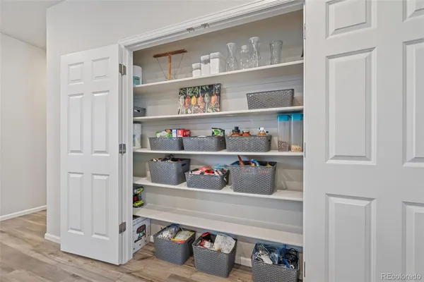 a room with a wooden floor and shelf