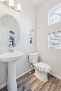 a bathroom with a sink toilet and a mirror
