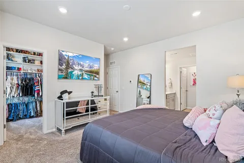 a bedroom with bed and a flat screen tv