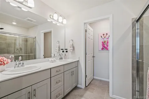 a bathroom with a sink vanity and a mirror