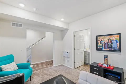 a bedroom with furniture and a painting