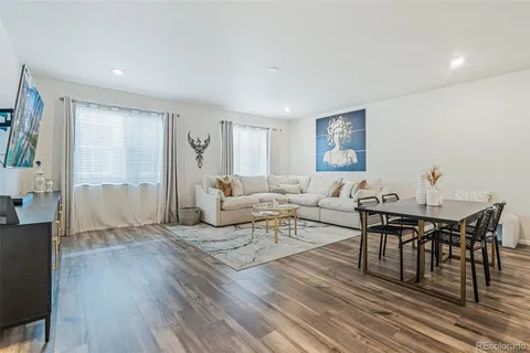 a living room with furniture and wooden floor