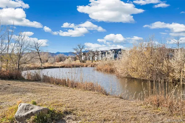 a view of a lake with houses in the background