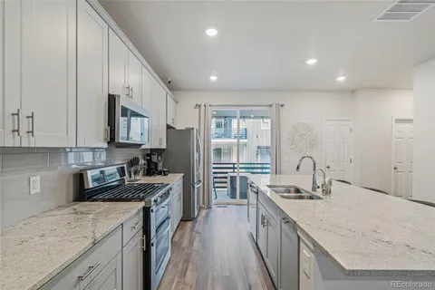 a kitchen with a sink stove and refrigerator