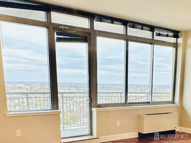 a view of a room with wooden floor and windows