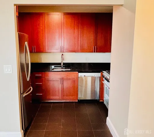 a view of a room with wooden floor and a window