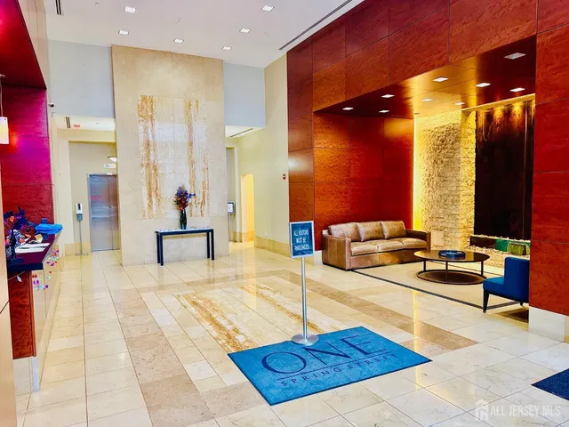 a view of a bedroom with wooden floor and bathroom