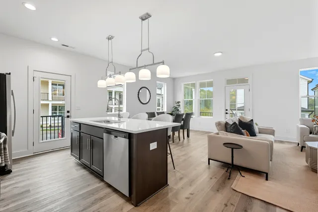 a view of a kitchen area with furniture and wooden floor